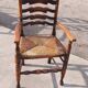 Set of 4 rustic vintage armchairs in English farmhouse style with rush seats.