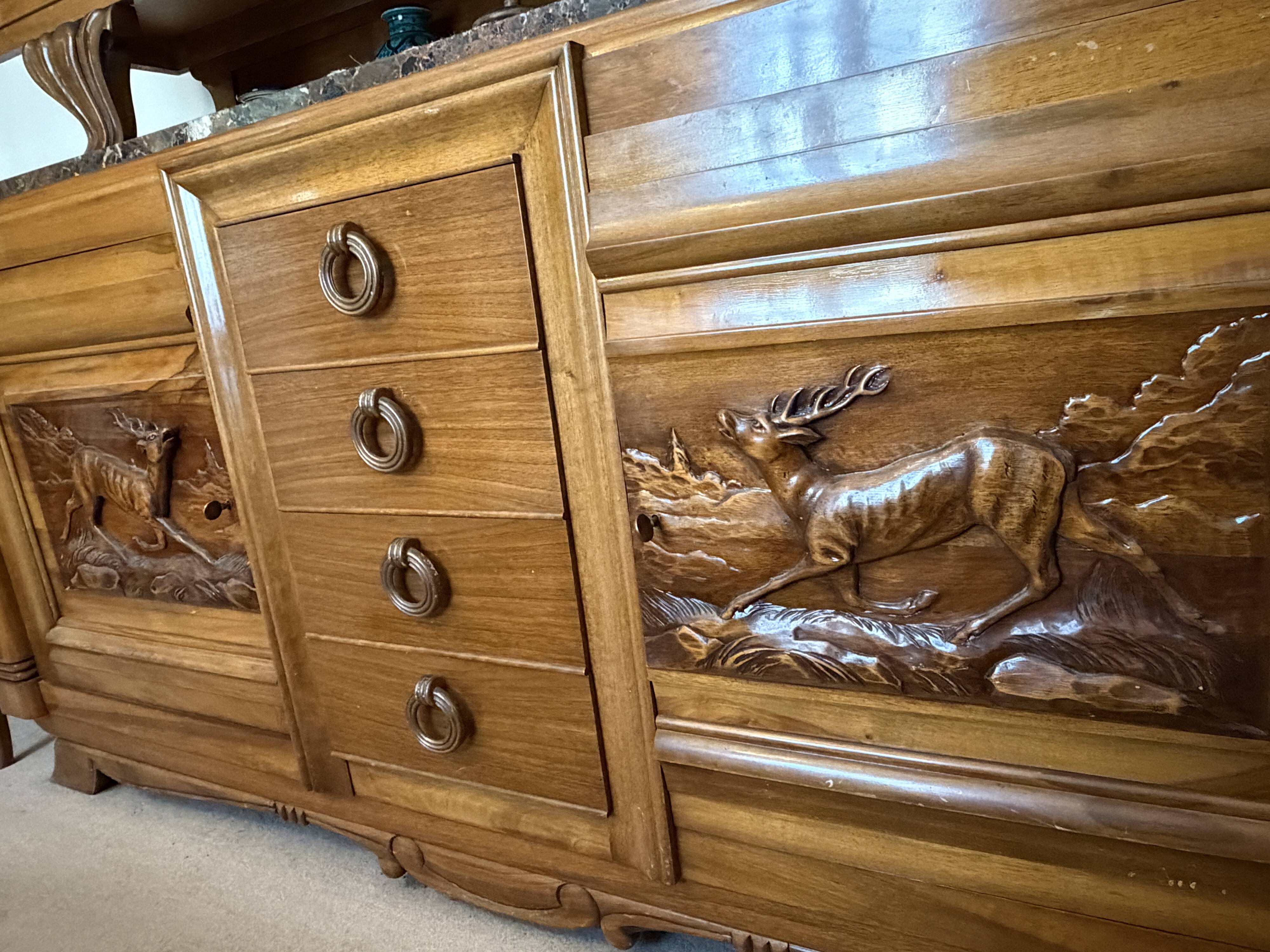 Solid wood sideboard with marble top and carved panels.