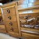 Solid wood sideboard with marble top and carved panels.