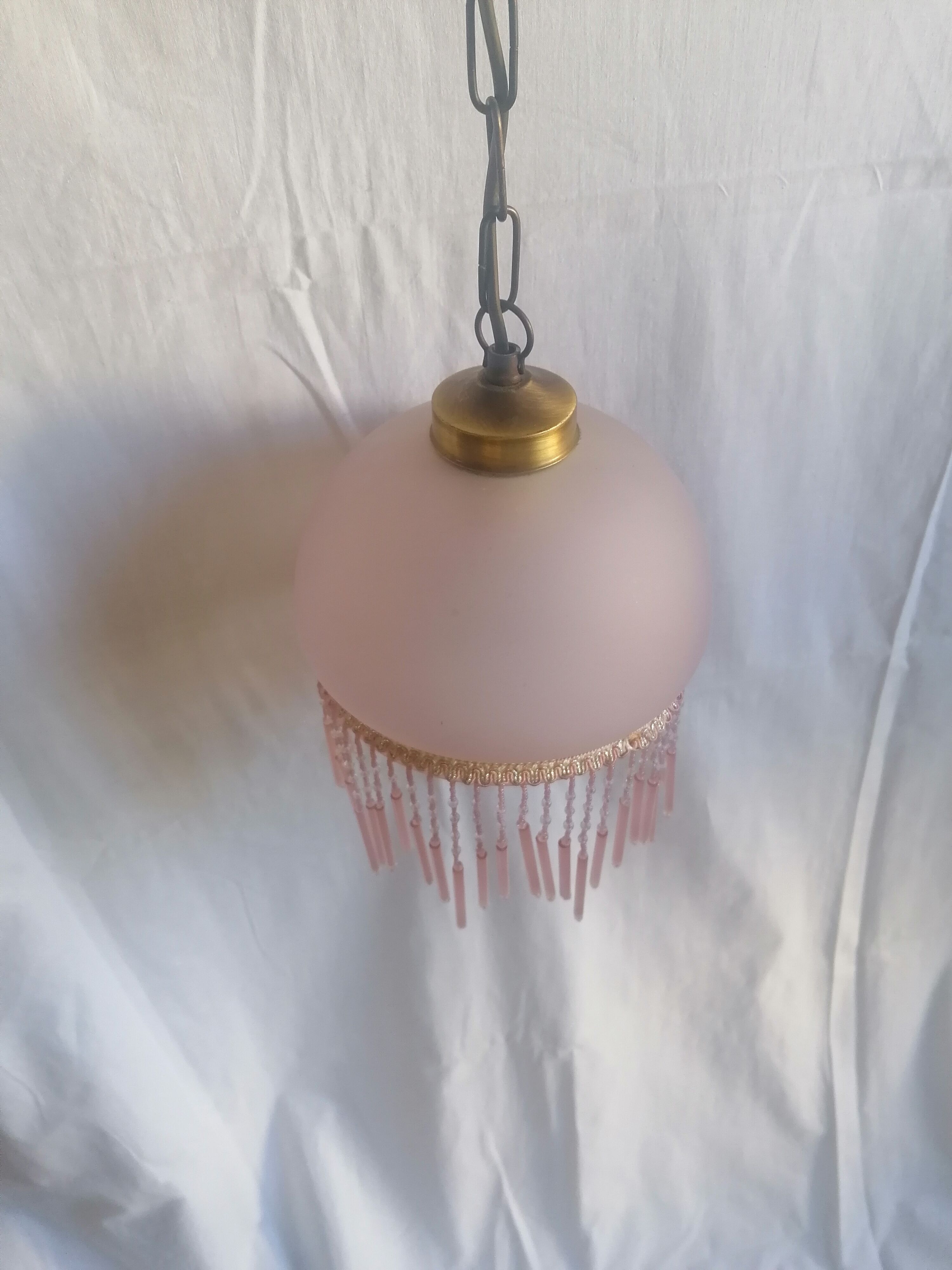 Hanging bell and pink glass garland