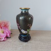 Small black cloisonné vase decorated with yellow and pink cherry blossoms, vase on wooden base