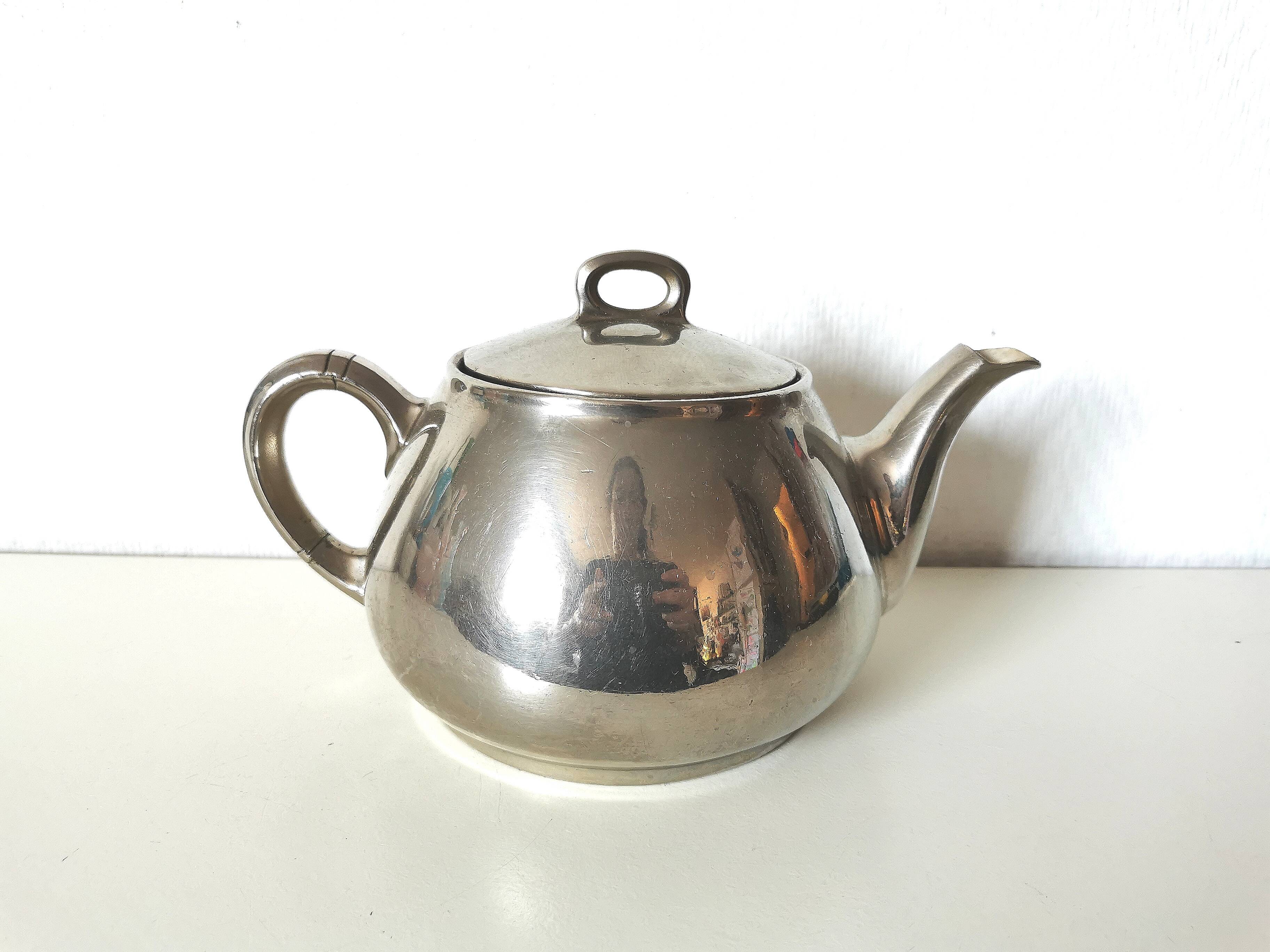 vintage teapot covered with silver metal
