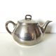 vintage teapot covered with silver metal