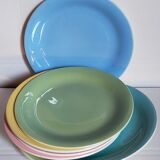 Seven pastel-colored plates mixed with vintage earthenware