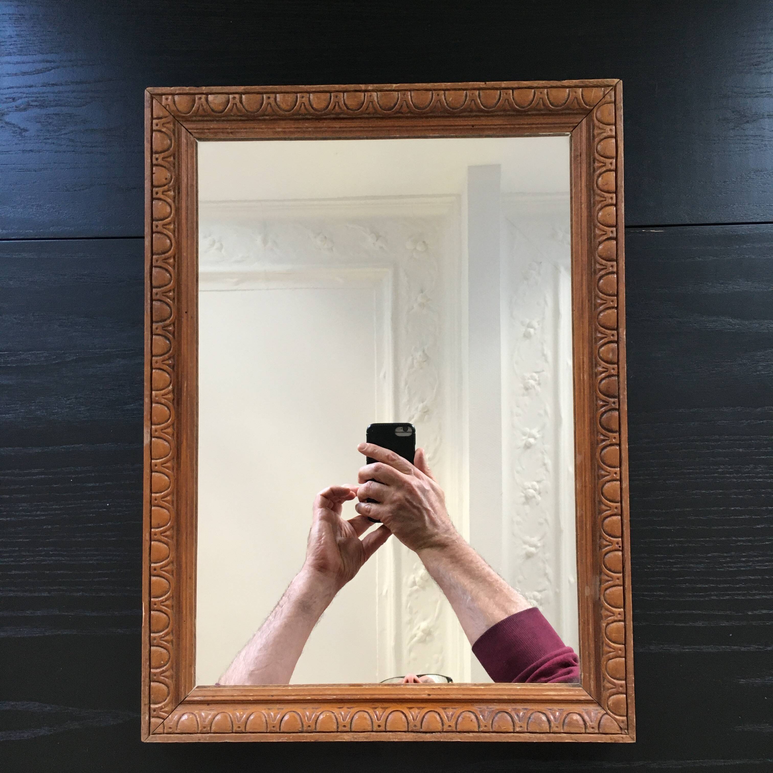 Antique mirror in ornate wood