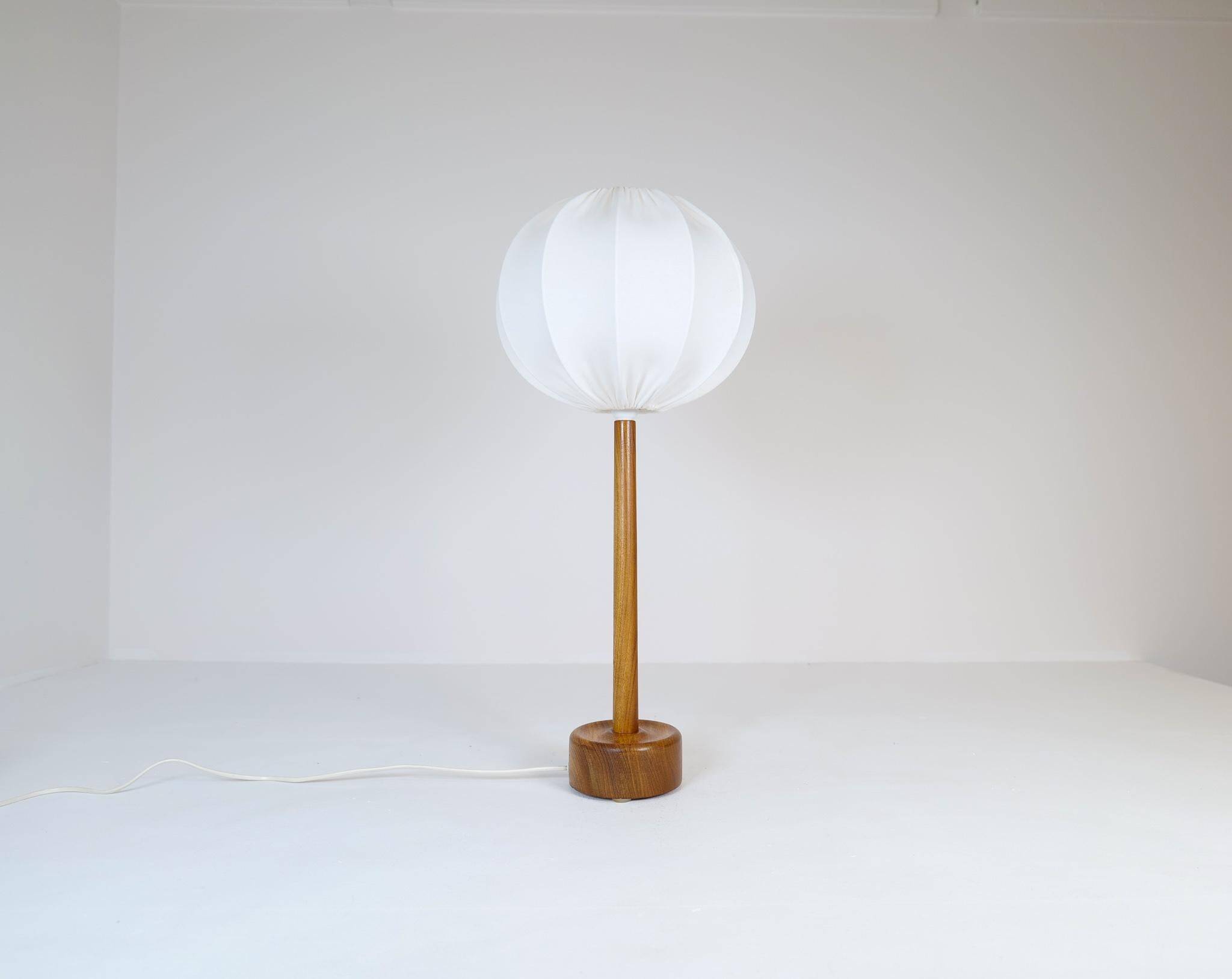 Mid-century solid teak table lamp from the 1960s Sweden.