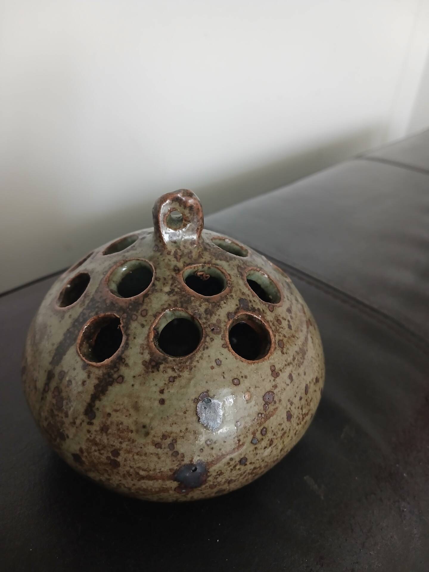 Wall-mounted round vase (flower holder) with the signature AG (Anne Marie Gassin).
