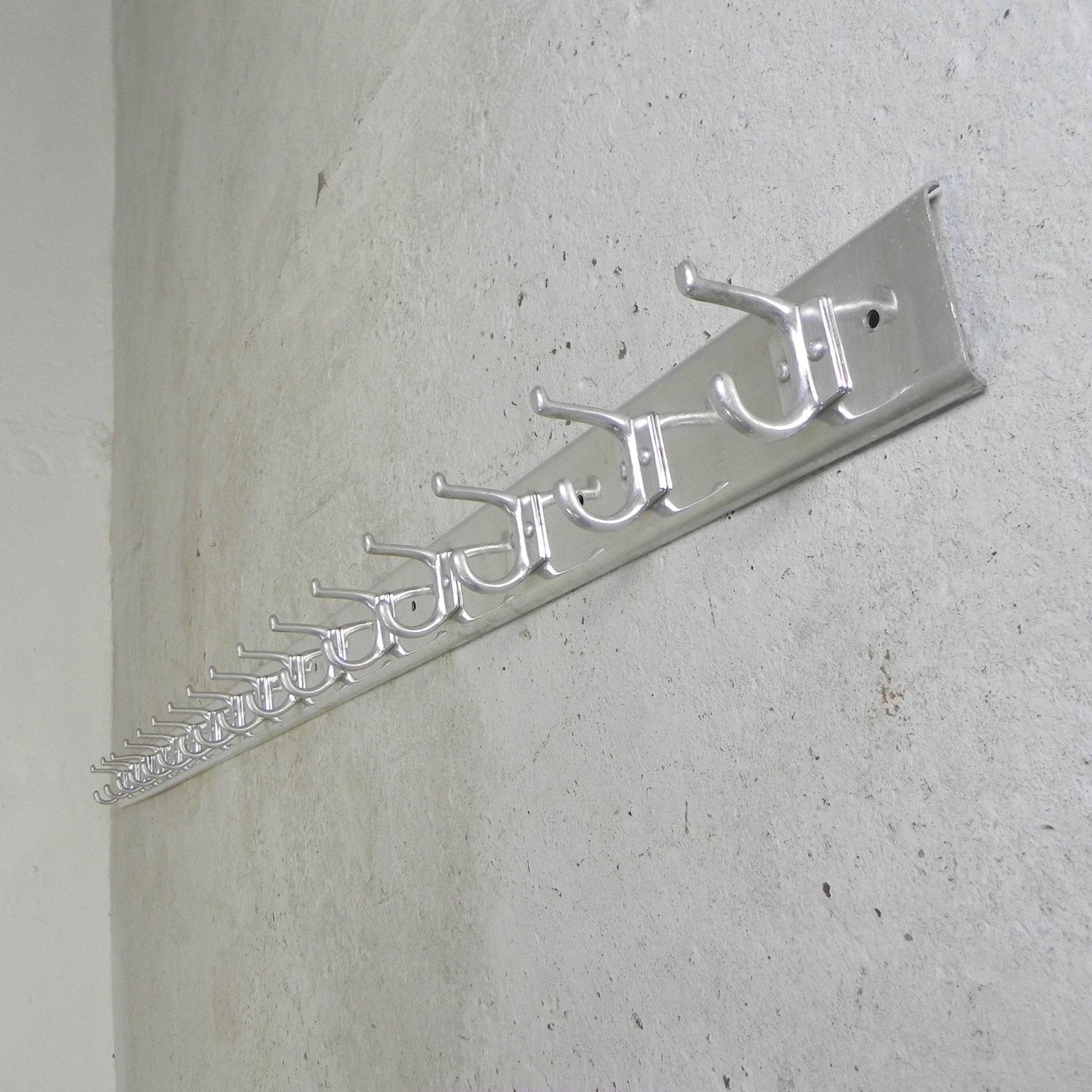 Wall-mounted aluminium coat rack of 225 cm with 16 double hooks, 1960s.