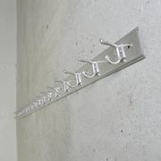 Wall-mounted aluminium coat rack of 225 cm with 16 double hooks, 1960s.