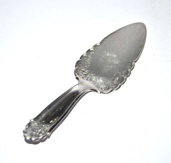Vintage silver-plated pie server with rose decoration.