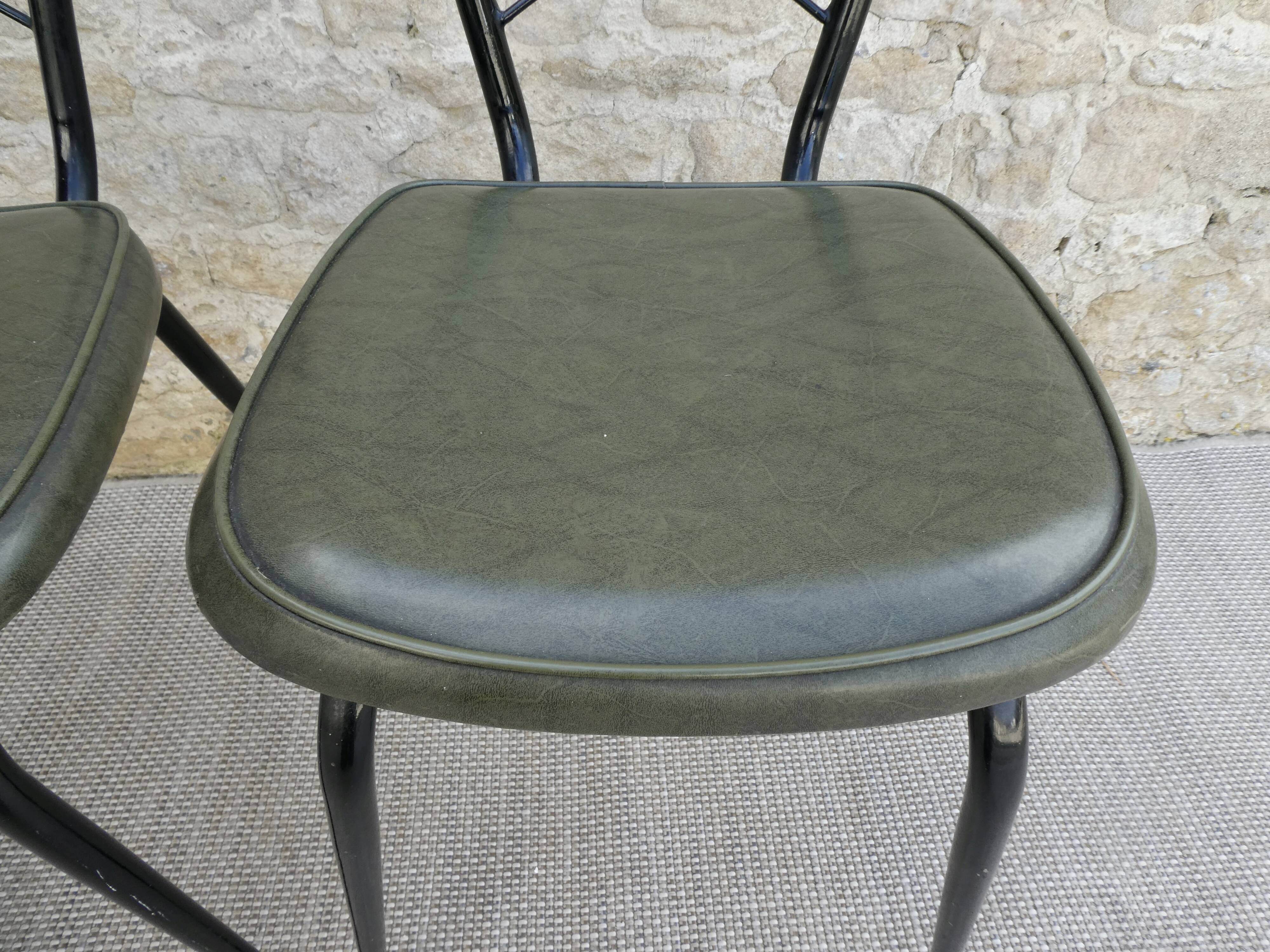 Pair of black metal chairs and khaki green skai, 60s