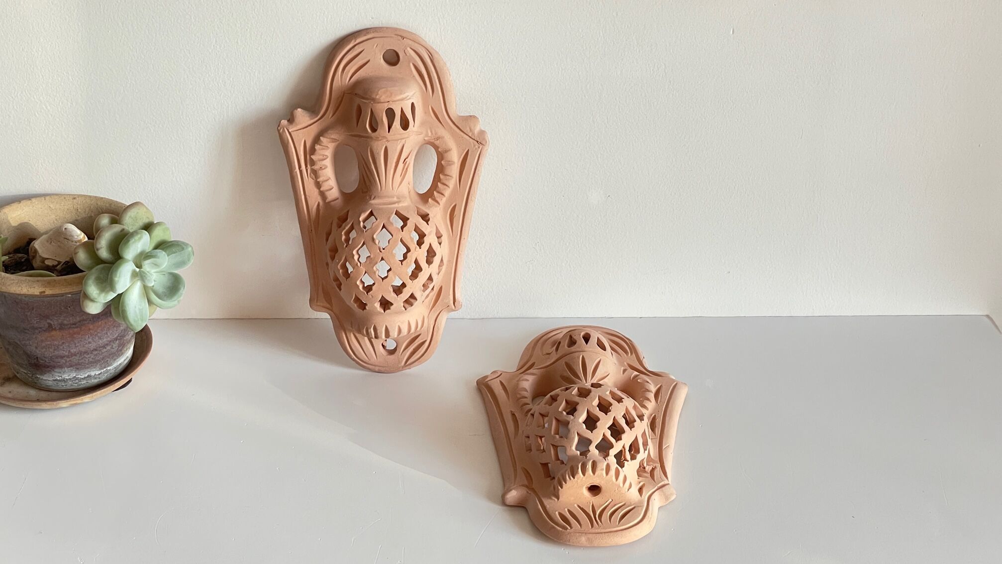 Pair of terracotta wall candle holders