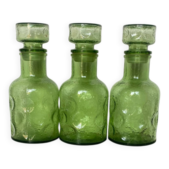 Set of three frosted glass carafes.