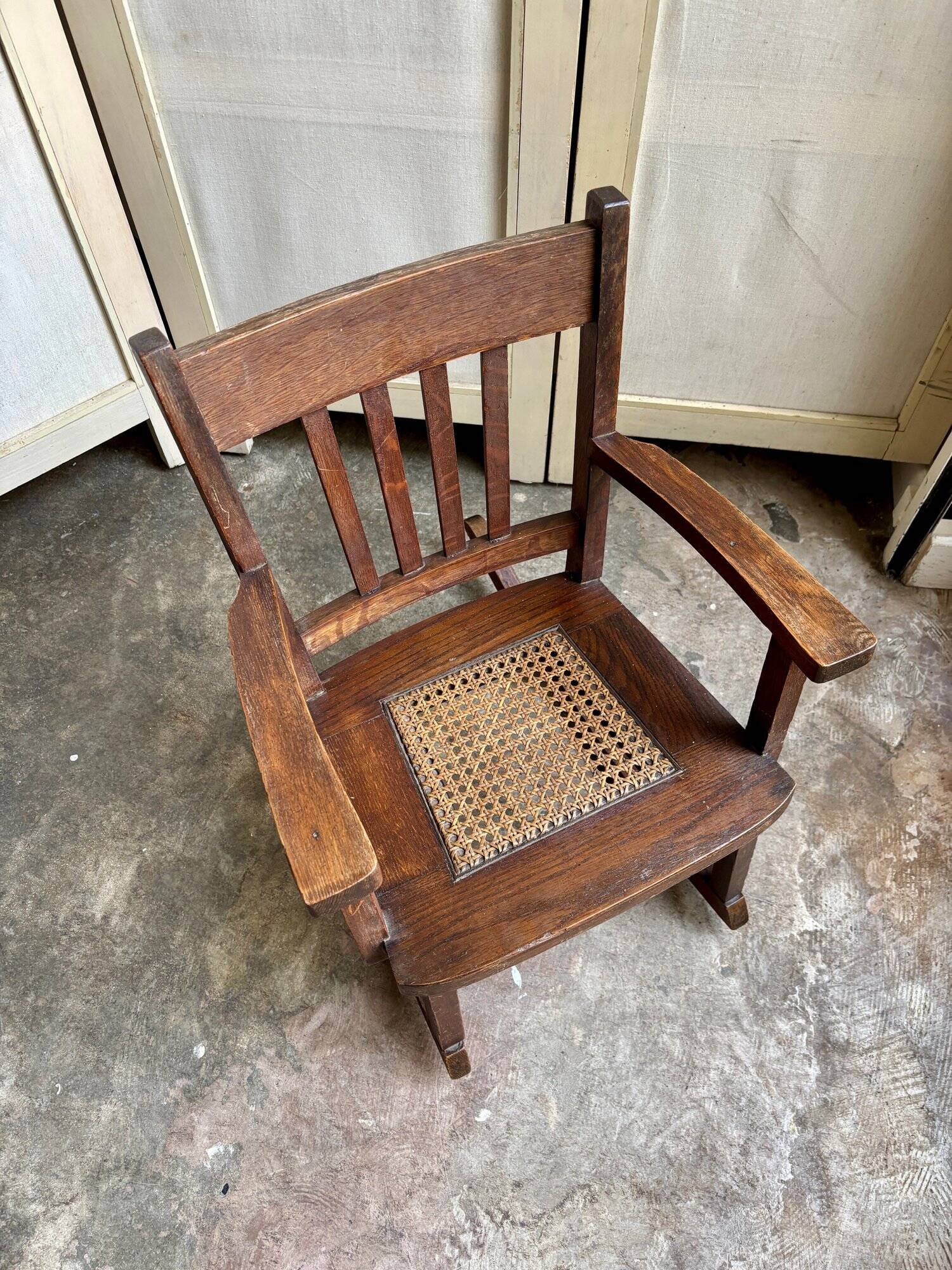 Children's rocking chair in dark wood and cane