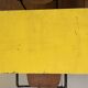 Table in the style of patinated yellow metal Tolix.