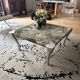 Contemporary coffee table with a marble top and steel base.