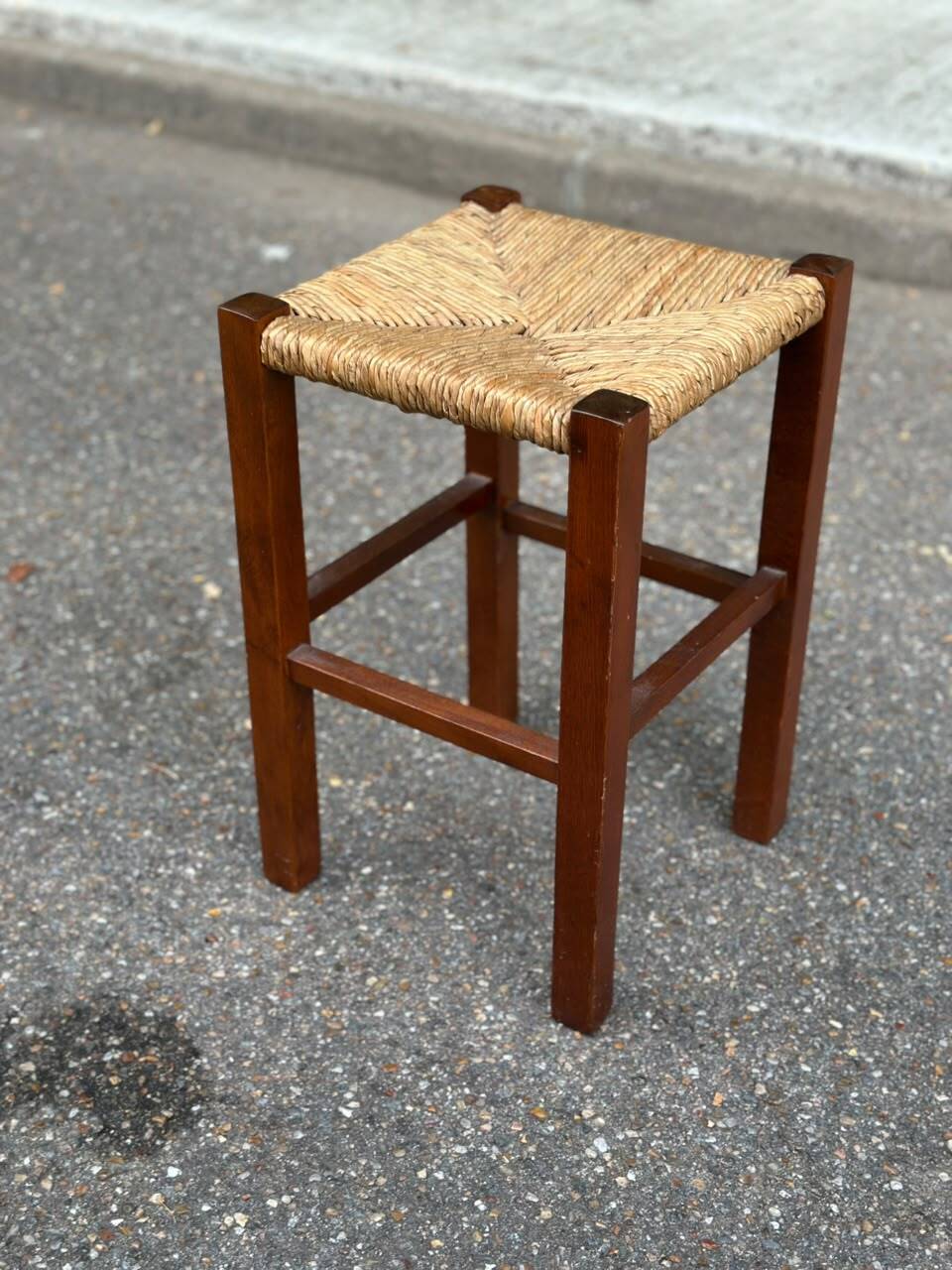 Low stool in brutalist style made of solid wood with straw, 1980.