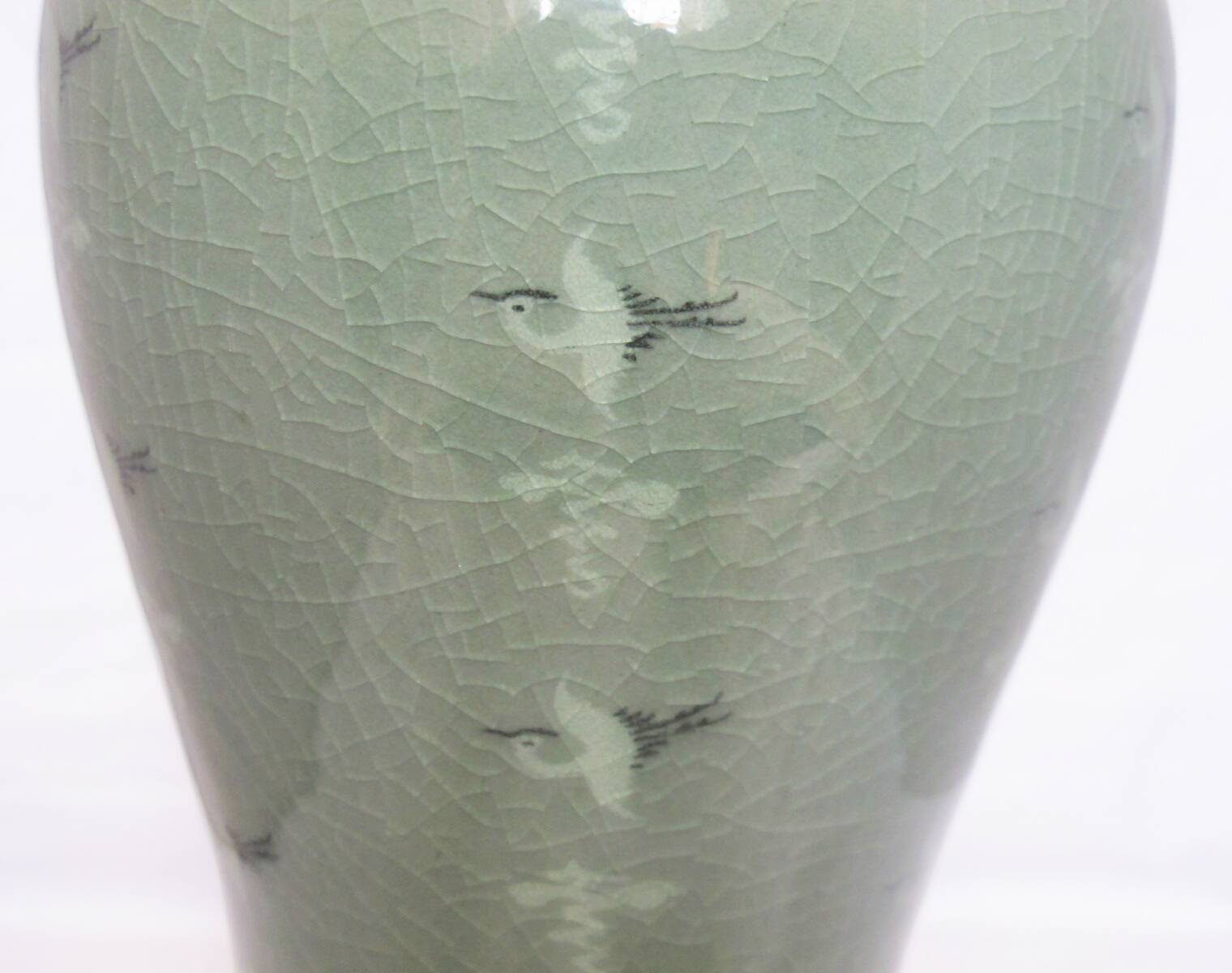 Korean vase in crackled celadon with a pattern of ducks and clouds.