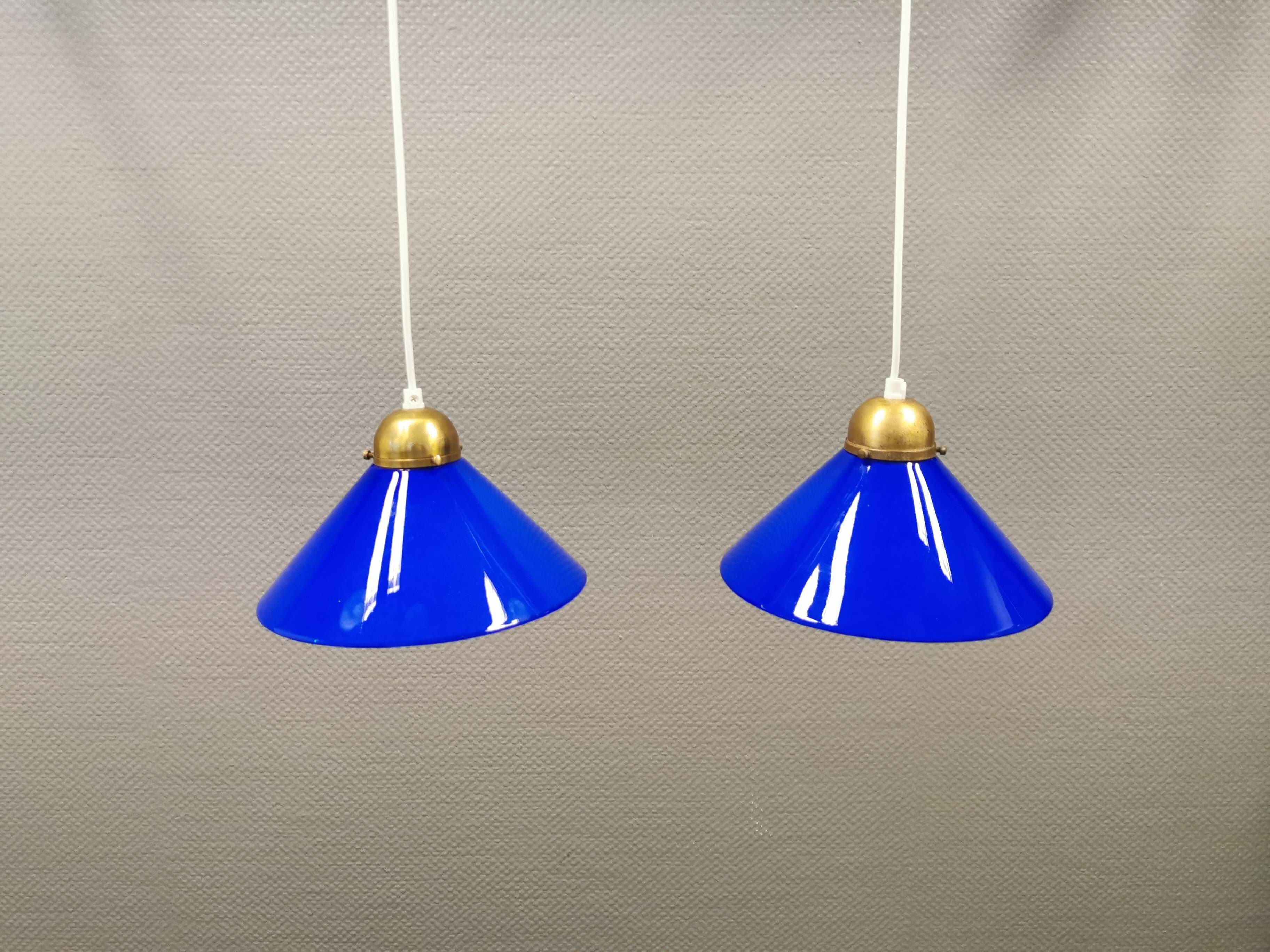Two lamps in double layered glass with brass top. Danish and estimated from the 1960s