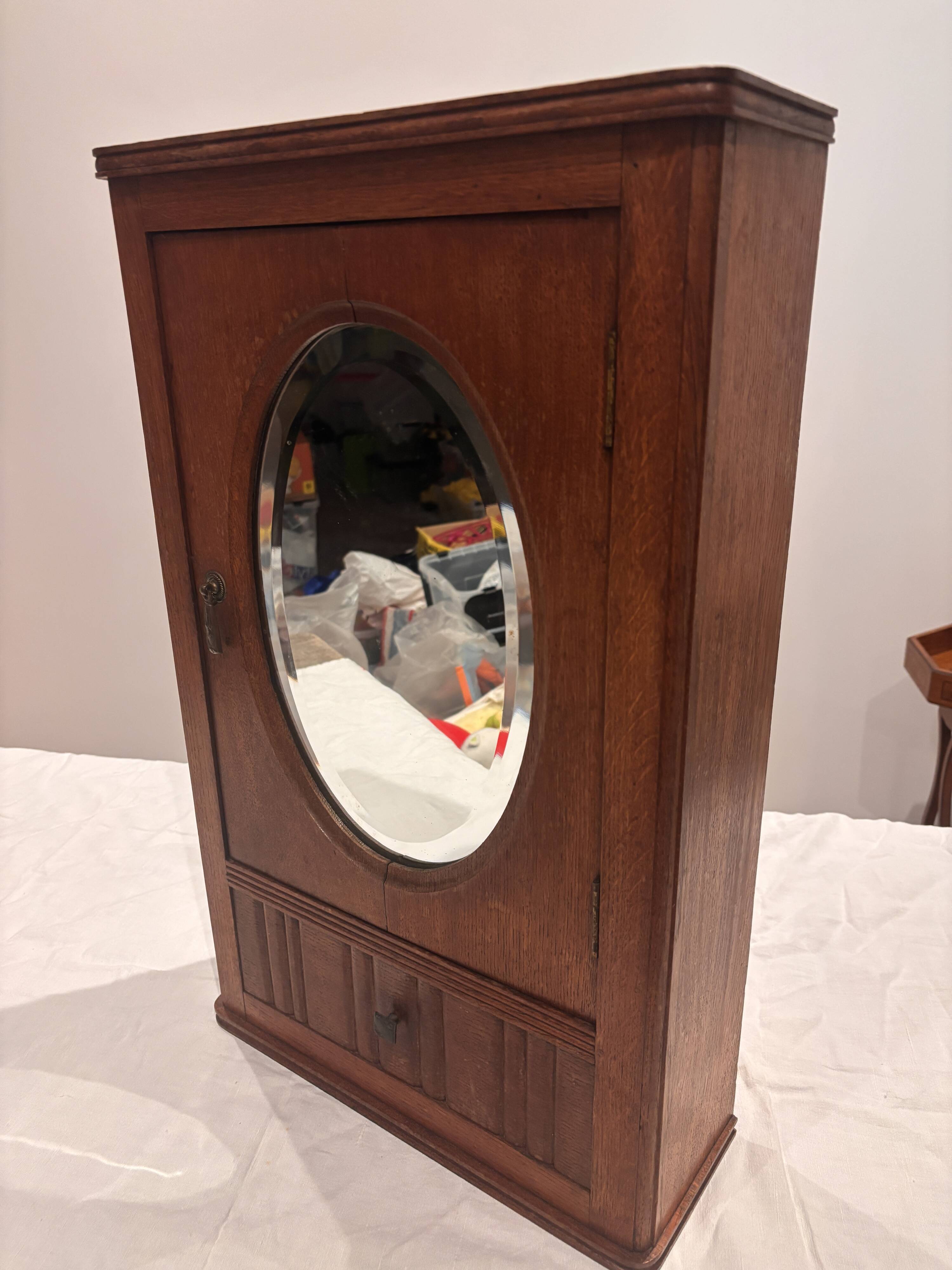 Wall cabinet with oval wall and drawer