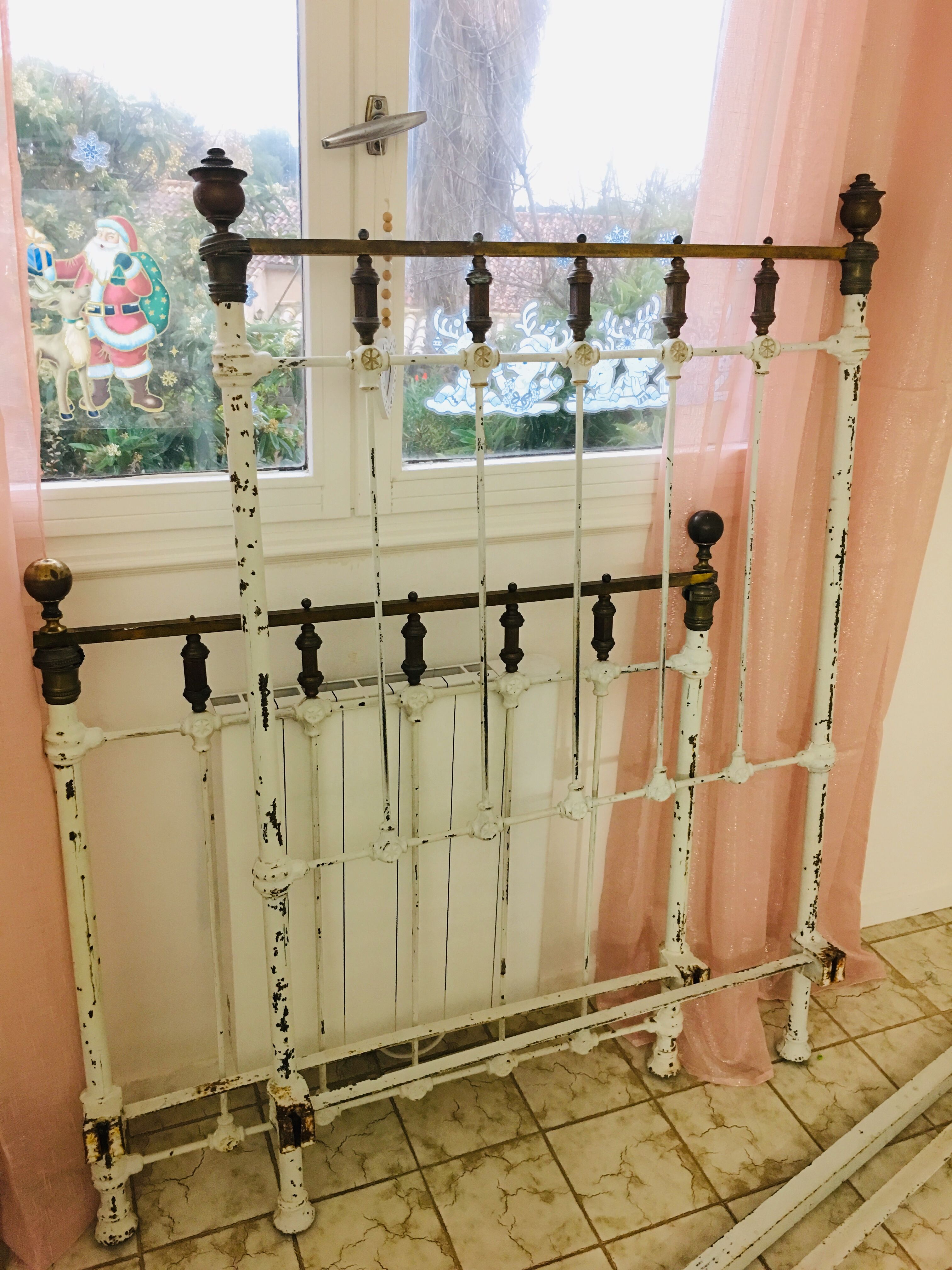 Old white metal and brass bed