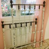 Old white metal and brass bed