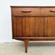 Teak Jentique sideboard — 1 door, 2 drawers & drop-down bar, England 1950s-60s