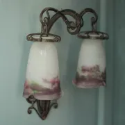 Wall lamp in wrought iron with a pink tulip glass globe by Muller glassworks.