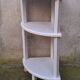 Small corner shelf in wood or corner unit.