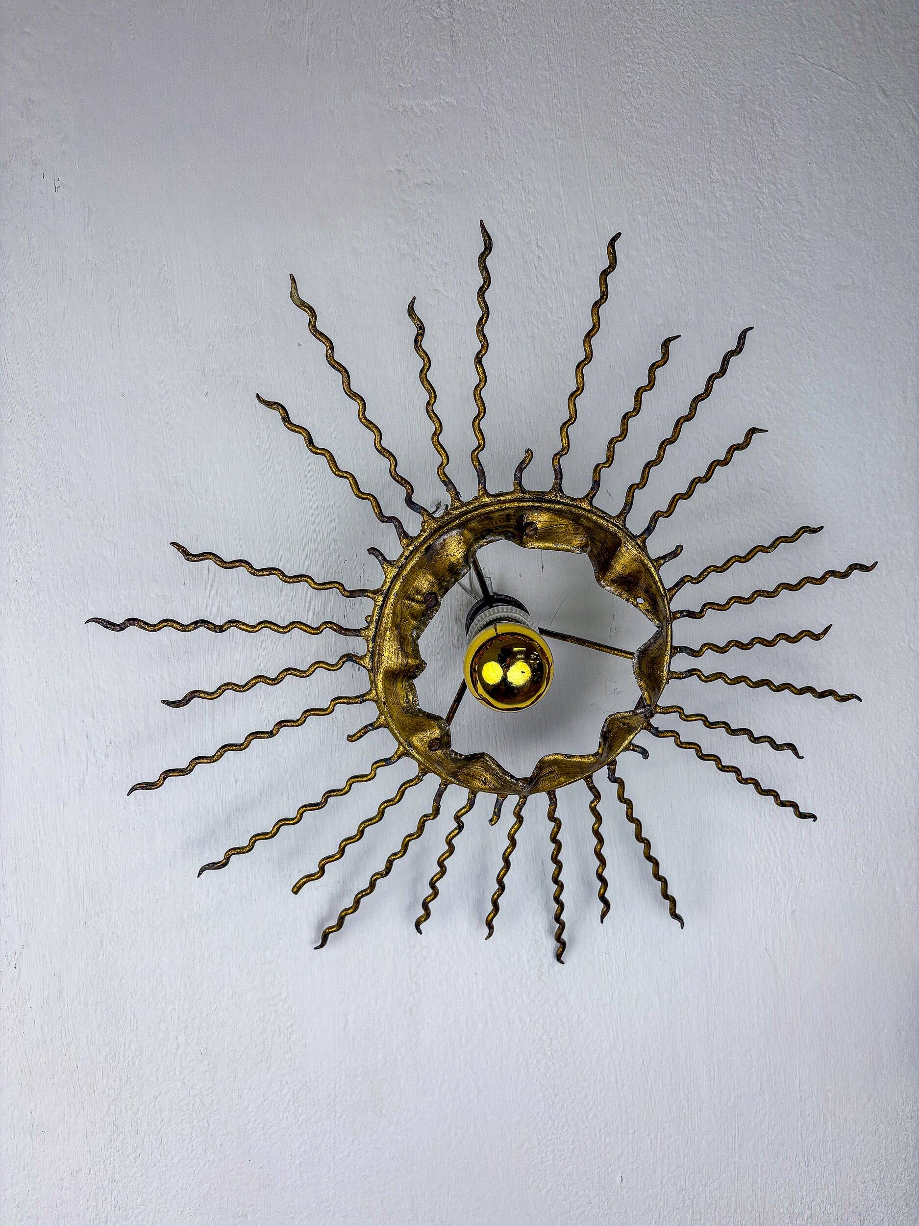 Spanish sunburst ceiling light – gilt iron rays & exposed bulb, 1960s