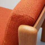 1970s chair in oak and orange cushions
