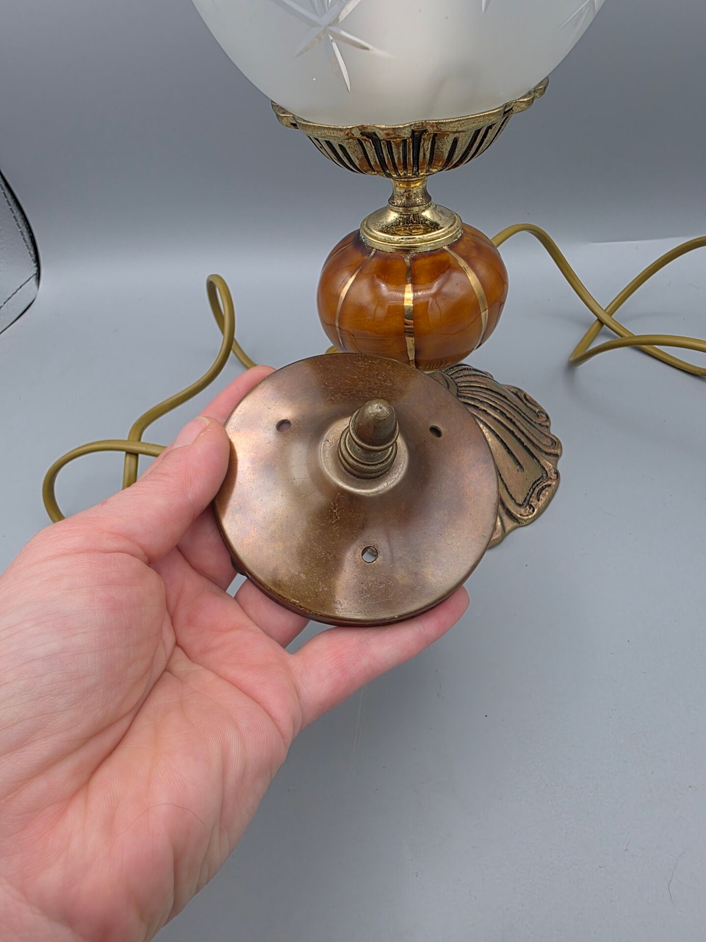Hollywood Regency bedside lamp in gold metal with a glass globe.