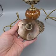 Hollywood Regency bedside lamp in gold metal with a glass globe.