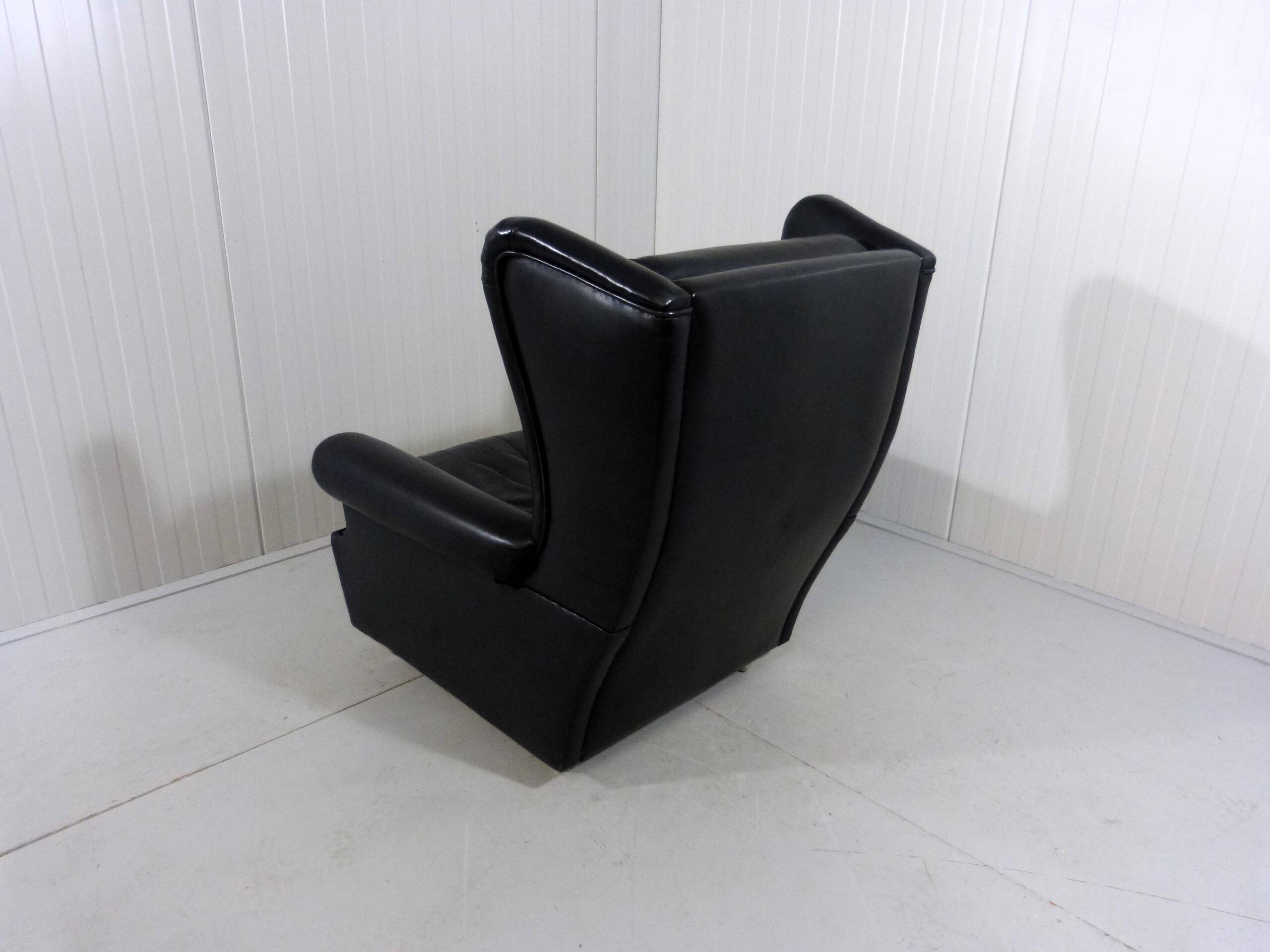 Black leather wingback chair on wheels 1960’s