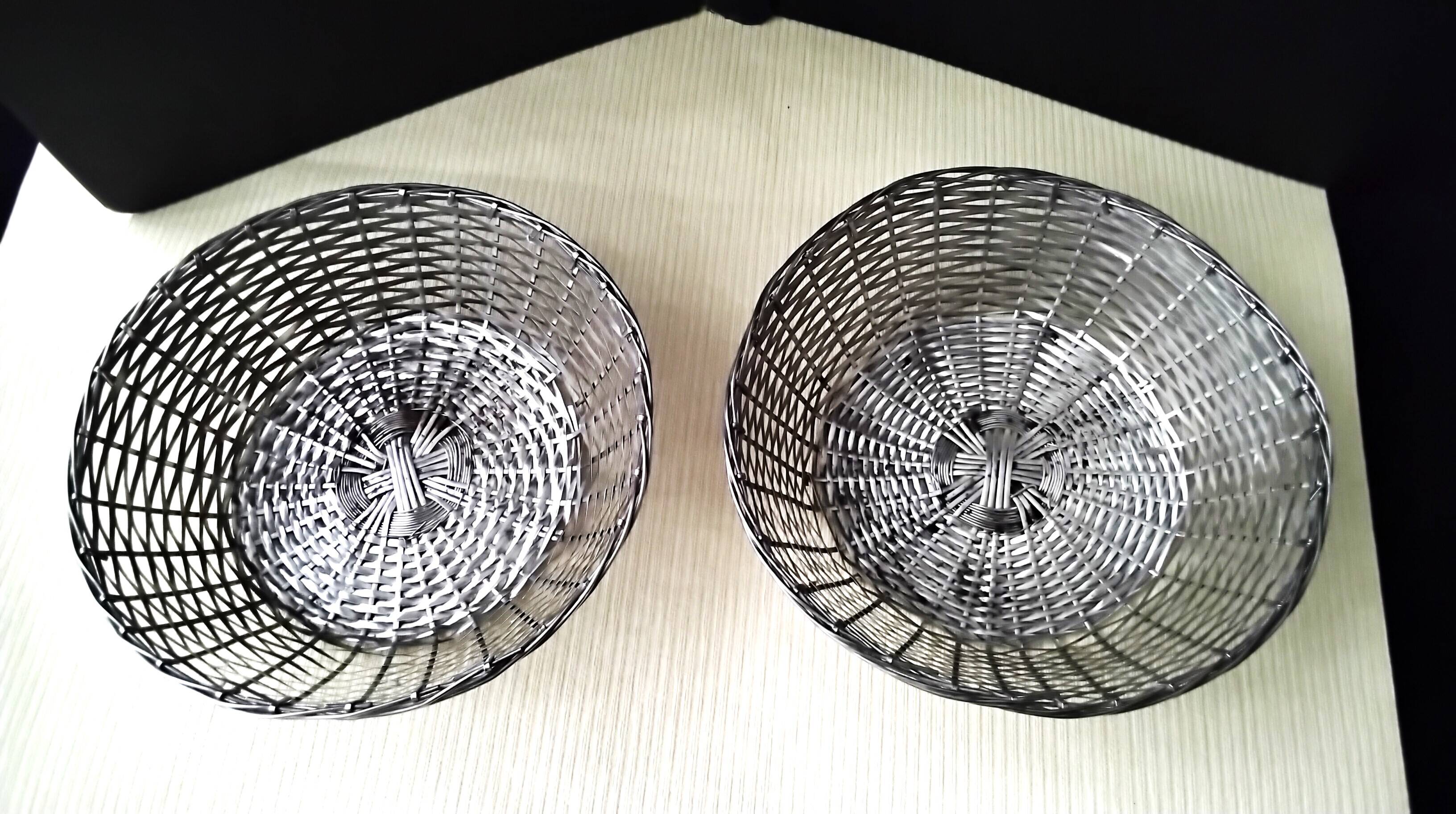 Pair of bread baskets, woven silver-plated wire baskets