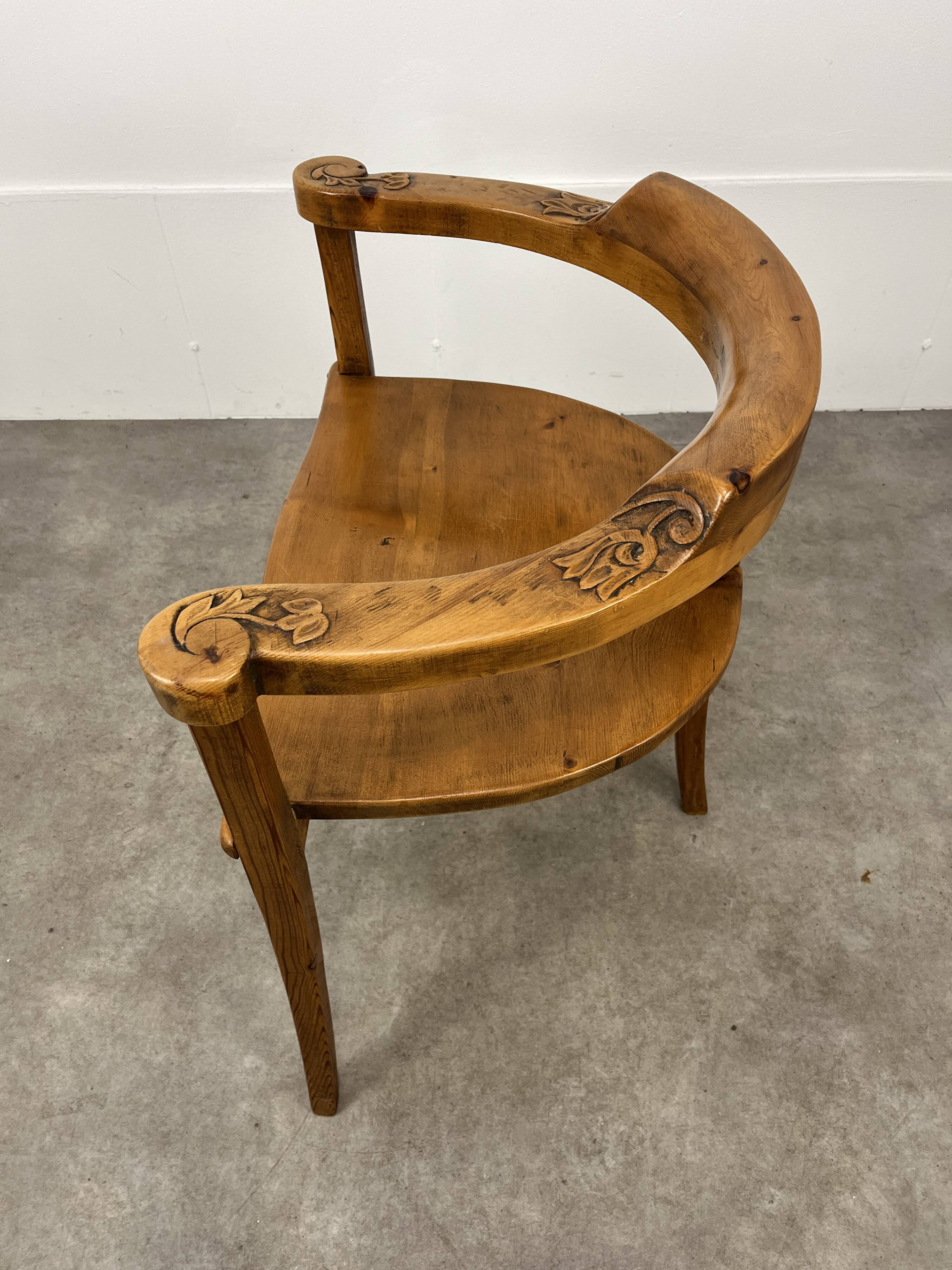 Chalet-style carved wooden tripod armchair
