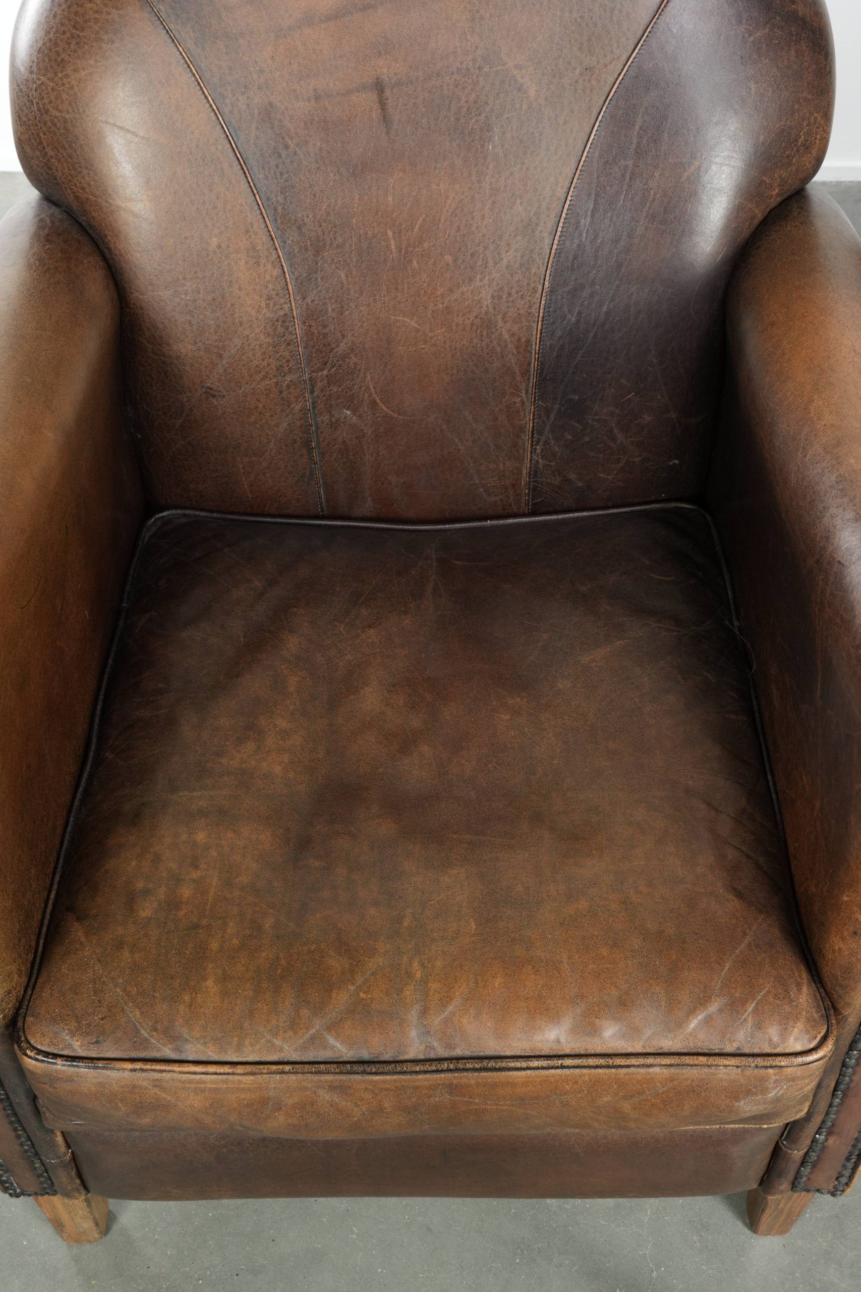 Characterful set of two sheepskin design armchairs with beautiful patina