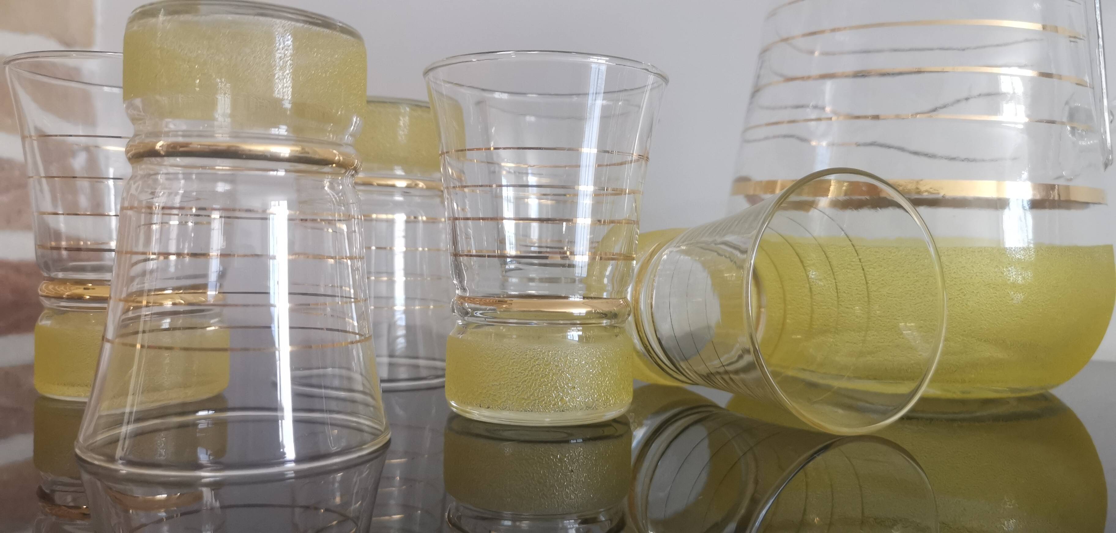 Old pitcher with its 8 yellow granite glasses with gold edging vintage 50's
