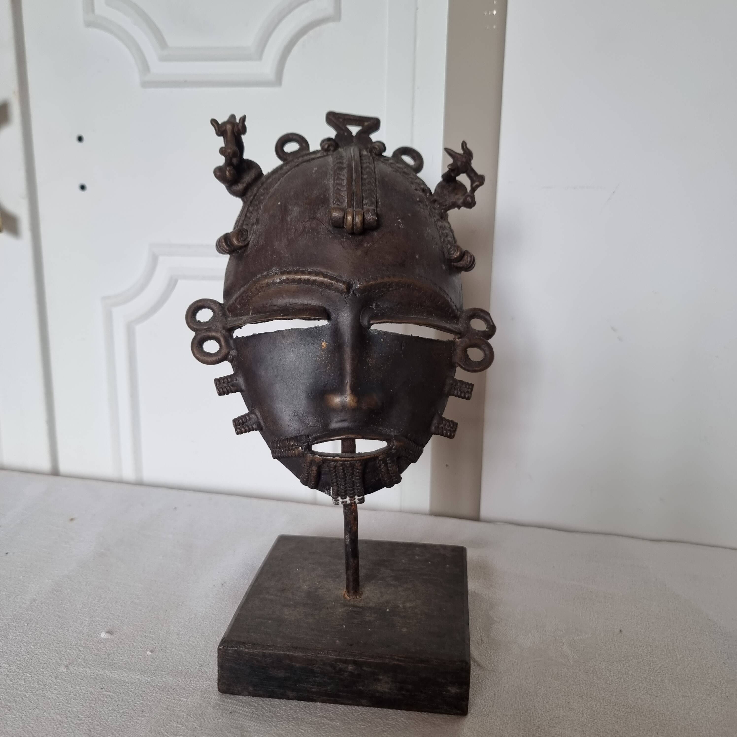 African bronze mask on pedestal, from Ivory Coast, dating