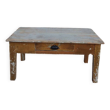 Patinated coffee table with a drawer