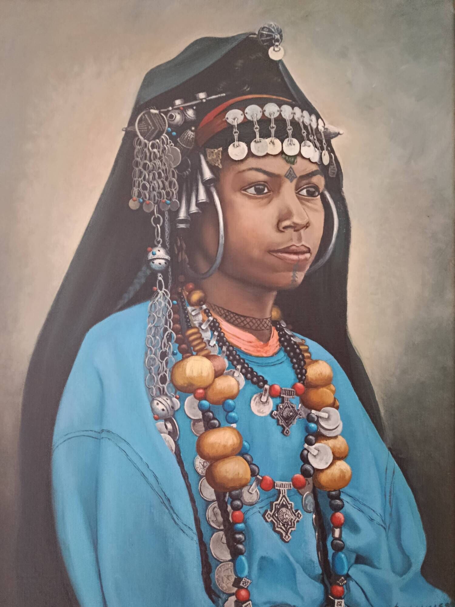 Portrait of a young Moroccan woman in traditional attire and adornments.