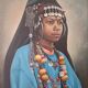 Portrait of a young Moroccan woman in traditional attire and adornments.