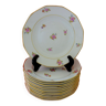 Suite de douze (12) assiettes à potage dodécagonales en porcelaine de Limoges à décor floral