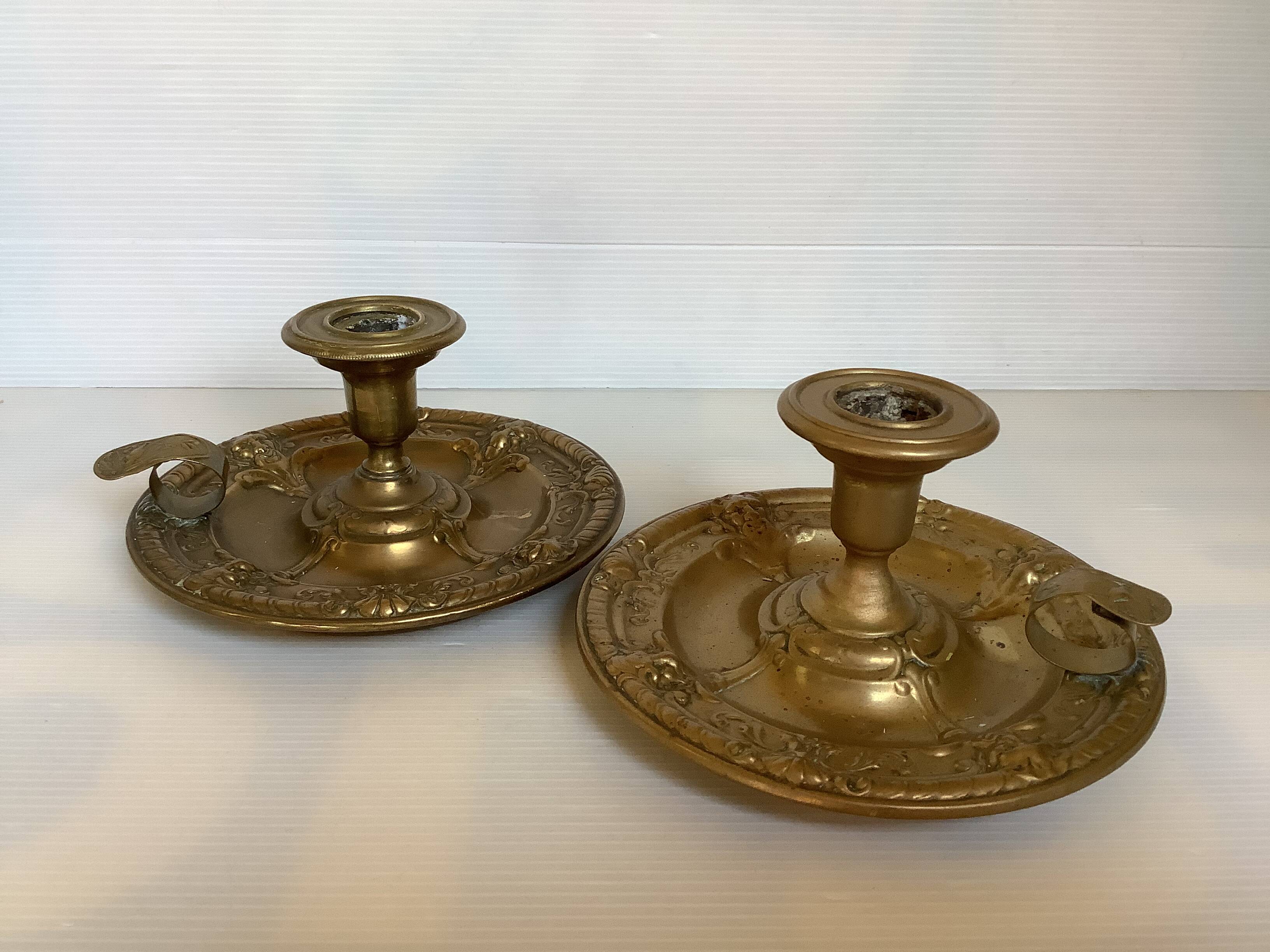 Pair of brass cellar rat candlesticks mascarons