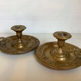 Pair of brass cellar rat candlesticks mascarons