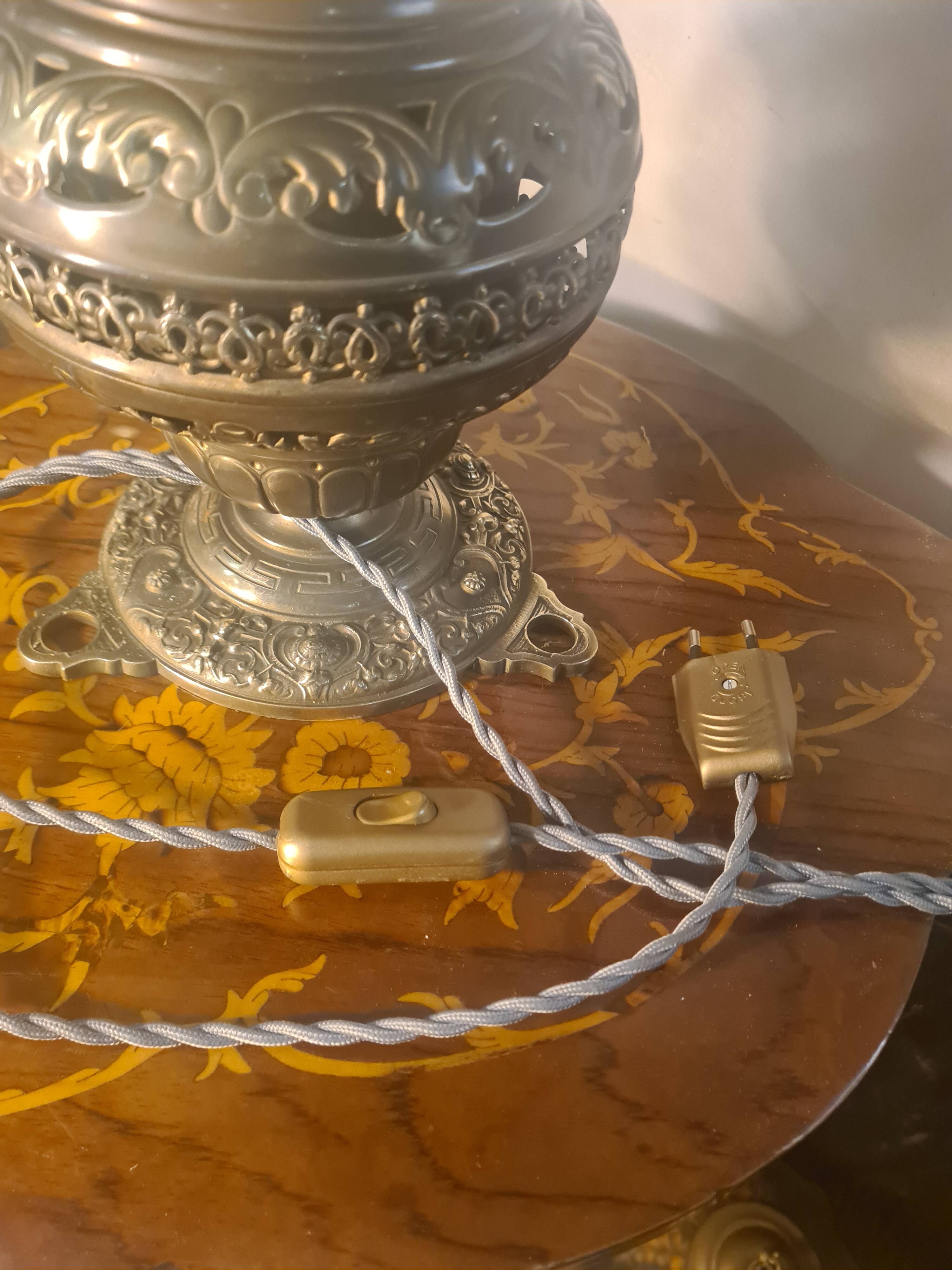 brass and bronze lamp with an antique base from 1900 and a glass paste shade