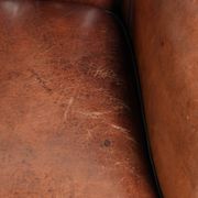 Comfortable sheepskin armchair in unique design finished with black piping