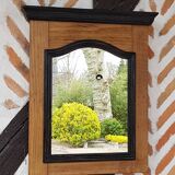 Black mirror and raw natural wood