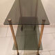 Vintage rolling dessert trolley with smoked glass trays and a golden base.