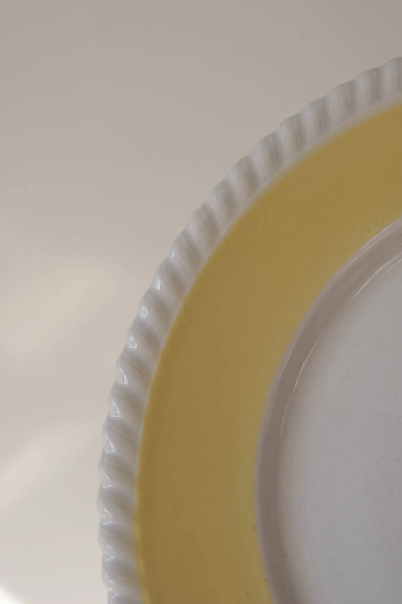 Vintage yellow butter ceramic dinnerware set with swirl border.